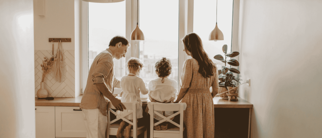Parents with two young children at a sunny kitchen counter, the kind of family that needs a guardian named in a will
