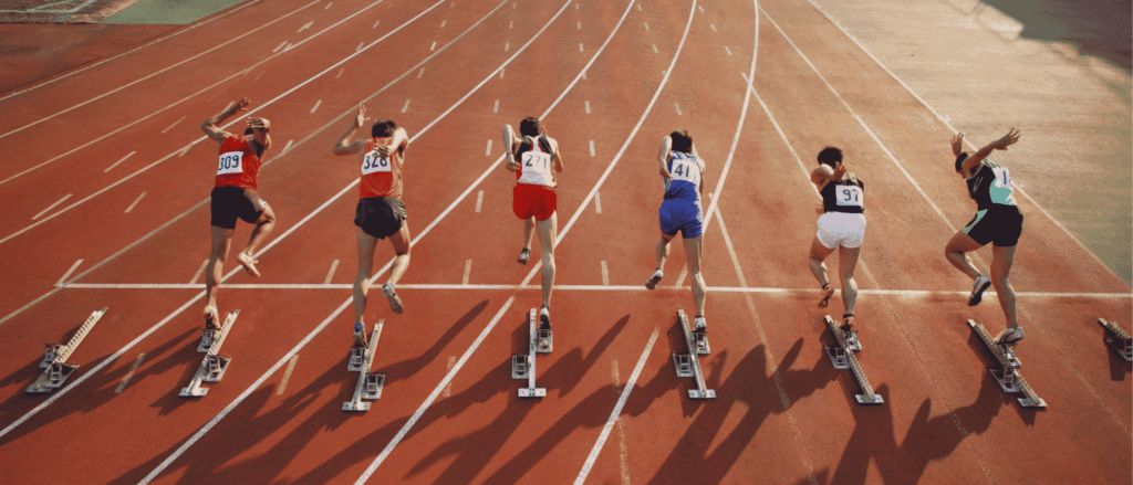 Sprinters launching from their starting blocks, like investors rushing to chase recent winners