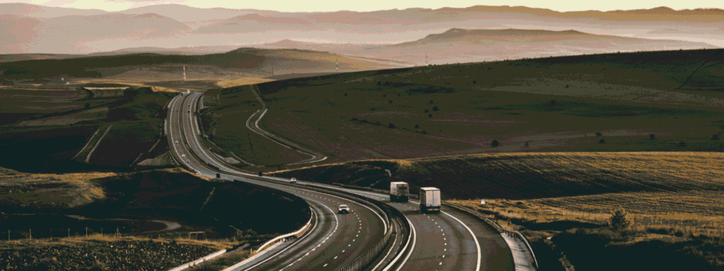 Winding highway through hills at dusk, like the long road from saving to retirement