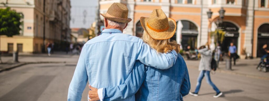 Active retired couple hiking a mountain trail during the early, more active years of retirement
