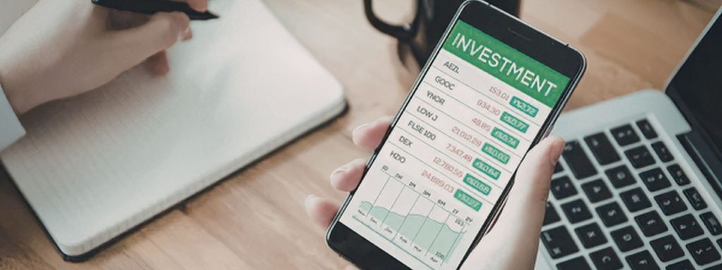 Investor reviewing a portfolio on a laptop to look for tax-loss harvesting opportunities