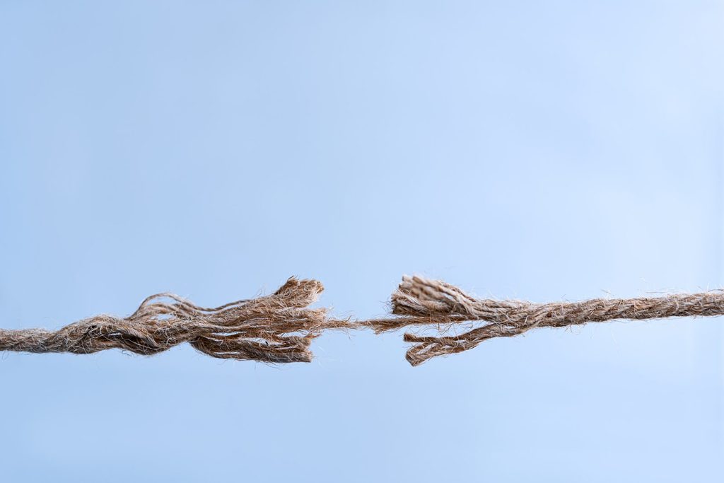 Fraying rope about to snap, illustrating trade tensions between the U.S. and Canada