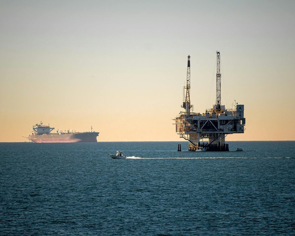 Offshore oil rig and tanker at sunset, as oil prices reached a seven-month high in February 2026